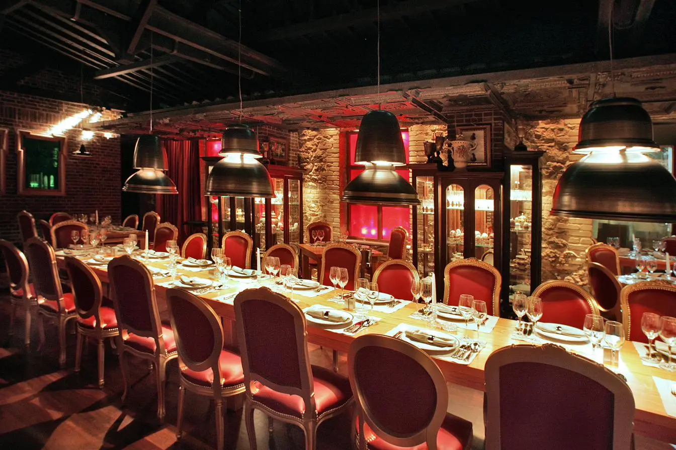 Baraonda restaurant lighting design Athens — oversized industrial pendants and brass accents