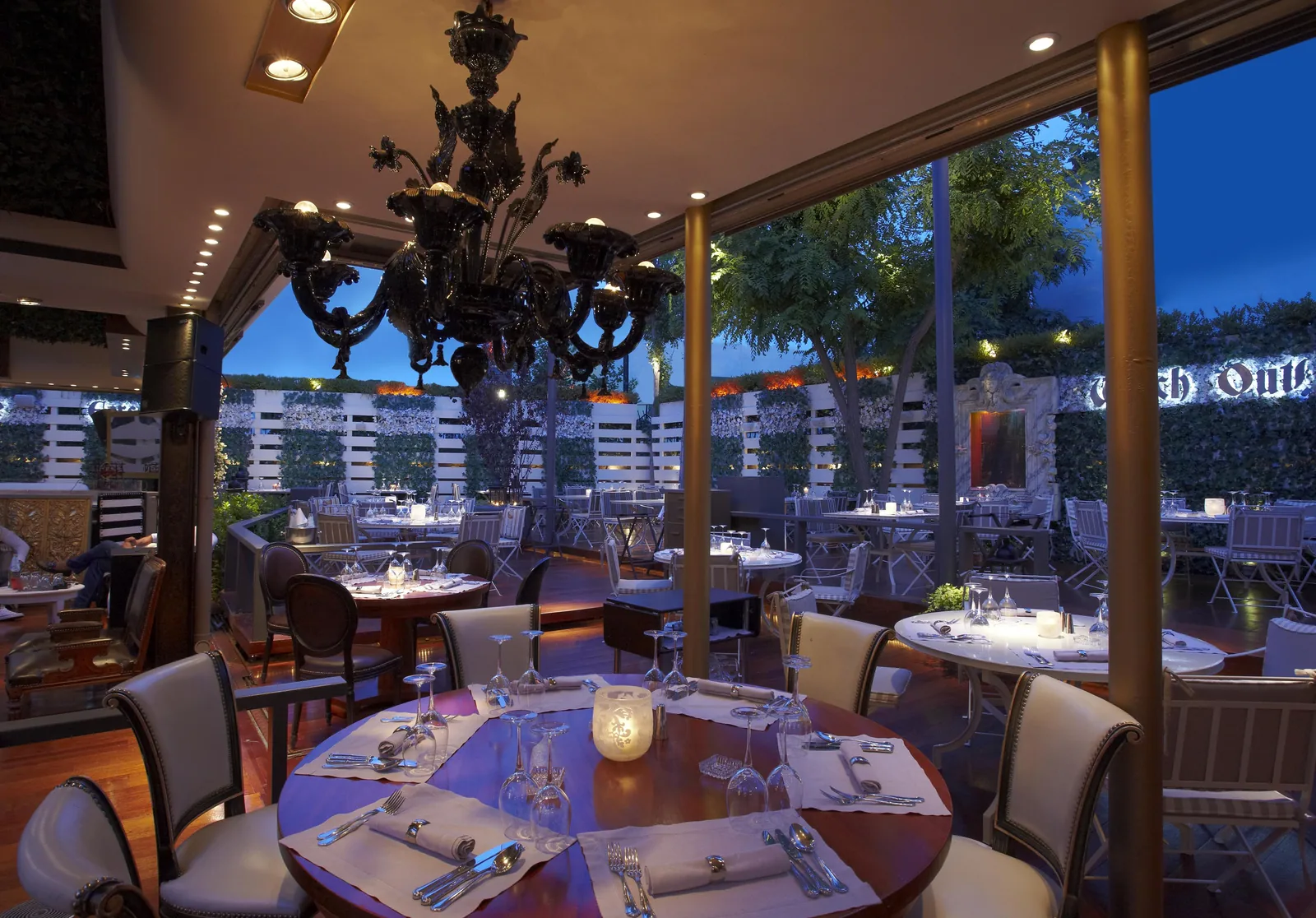Baraonda restaurant — Murano chandelier, concealed cove light and candlelit garden terrace, Athens